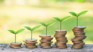 Coins stacks with plants a the top representing good budgeting